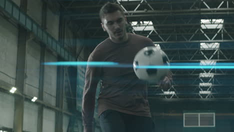Football-Athlete-Juggling-Soccer-Ball-on-Indoor-Field